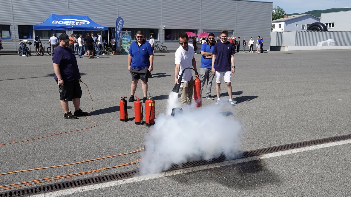 NOVOMATIC employee using a fire extinguisher in the yard of HQ in Gumpoldskirchen